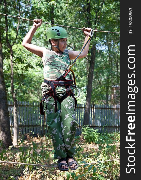 Portrait of boy wearing helmet and climbing. Child in a adventure playground. Portrait of boy wearing helmet and climbing. Child in a adventure playground