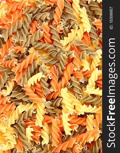 Raw colorful fusilli pasta in close up