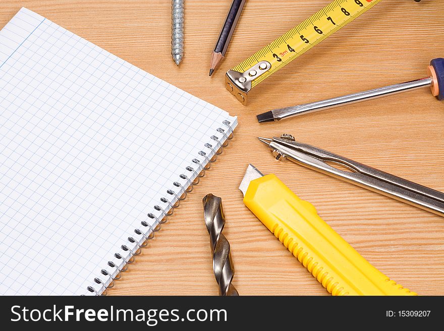 Note pad and tools on table