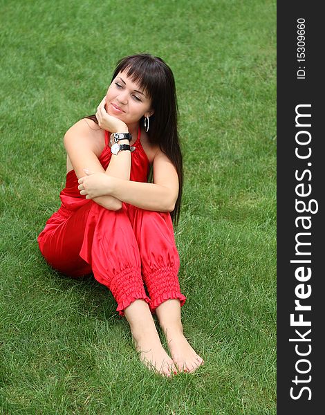 Brunette Girl In Red On The Grass