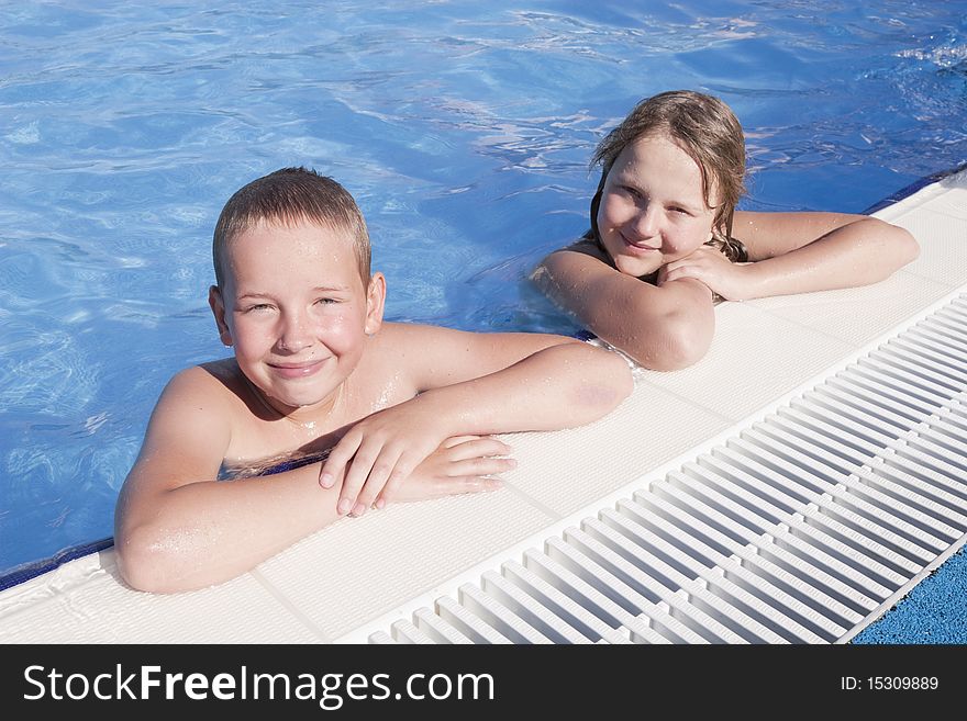 Girl and boy in swimming pool. Girl and boy in swimming pool