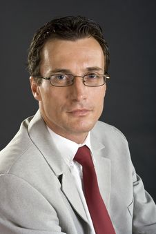 Man In Grey Jacket With Red Tie And Glasses Stock Image