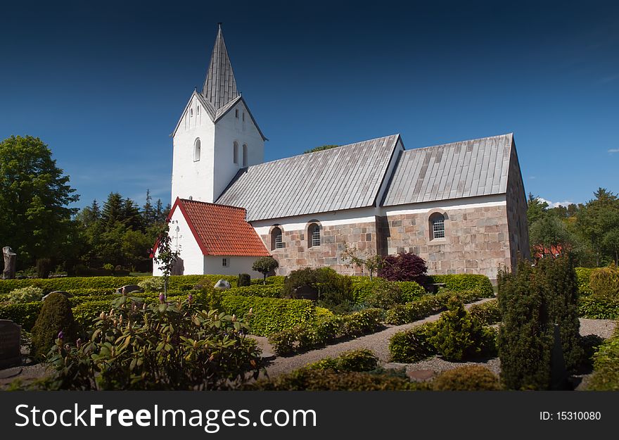 Typical danish lutheran church captured on a summers day with blue sky. Typical danish lutheran church captured on a summers day with blue sky.