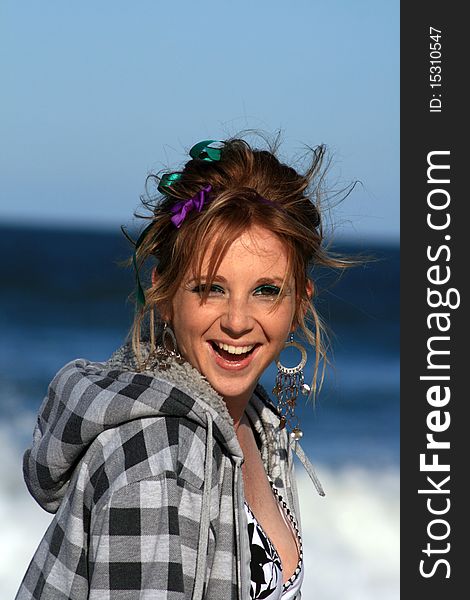 A beautiful white caucasian girl teenager with a happy expression on her face enjoying the beach. A beautiful white caucasian girl teenager with a happy expression on her face enjoying the beach