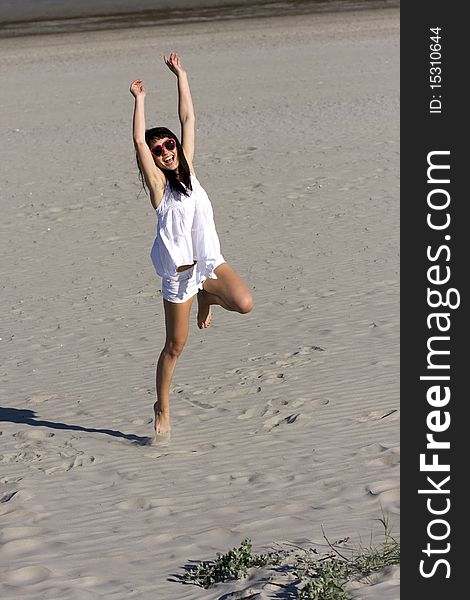 Young Atractive Woman Is Dancing On The Beach