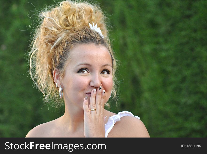 A beautiful young woman is looking to the sky with a very nighty expression in her face. A beautiful young woman is looking to the sky with a very nighty expression in her face.