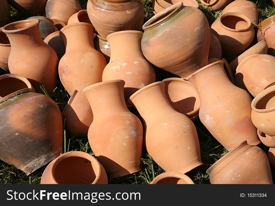 Traditional ukrainian clay pots lying on the grass