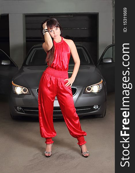 Girl in red near the car