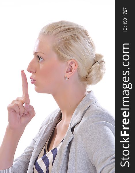 Woman with finger to mouth gesturing for quiet