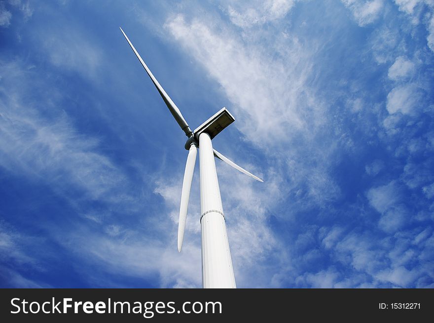 Big windmill and blue sky. Clean, green energy. Big windmill and blue sky. Clean, green energy.