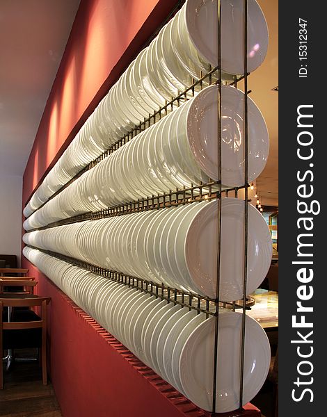 Wall decorated restaurant with dishes in a row