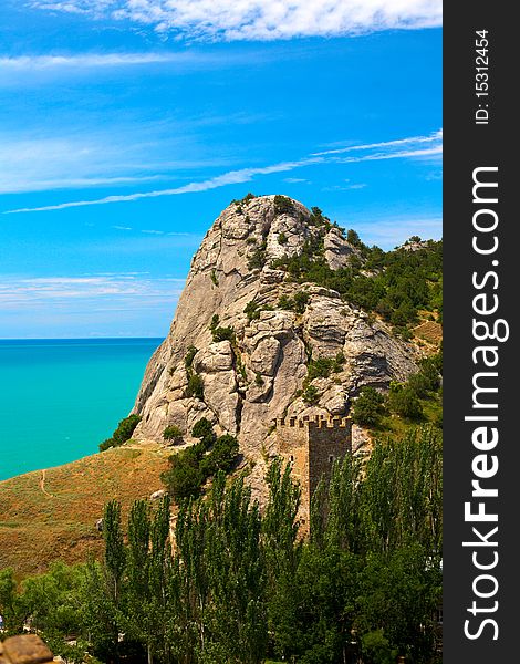 Sudak, Crimea, Ukraine. Rock, sea and single tower view. Sudak, Crimea, Ukraine. Rock, sea and single tower view