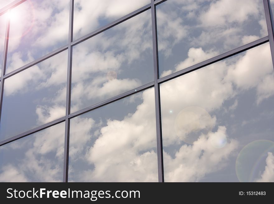 Reflection of blue sky with clouds in the glass surface. Reflection of blue sky with clouds in the glass surface