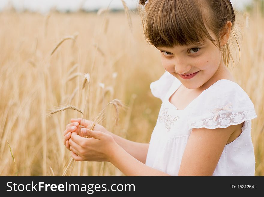 Girl on field holding spikes in hands made out. Girl on field holding spikes in hands made out