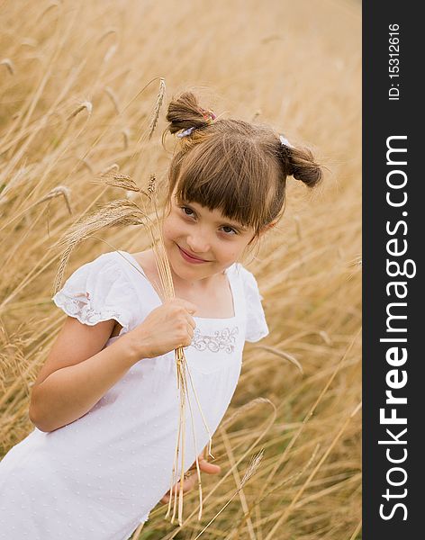 Girl on field holding spikes in hands made out. Girl on field holding spikes in hands made out