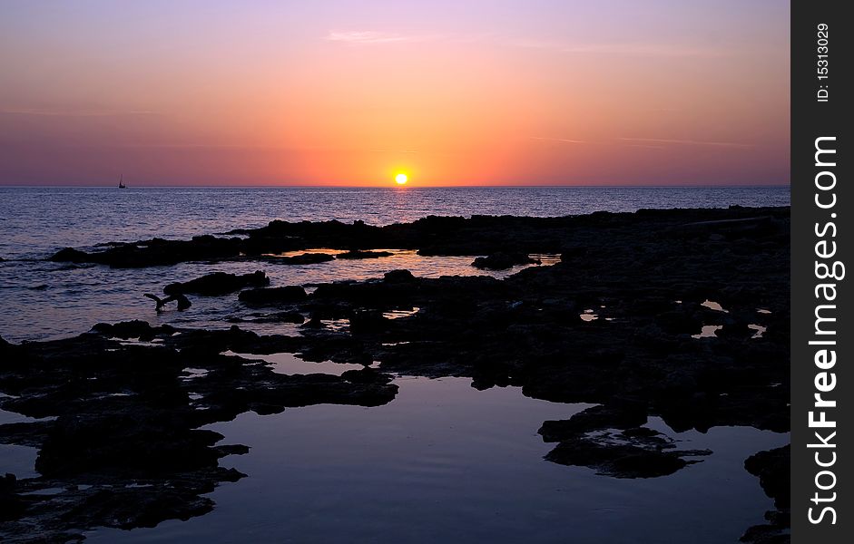 Sunset under the indented seashore