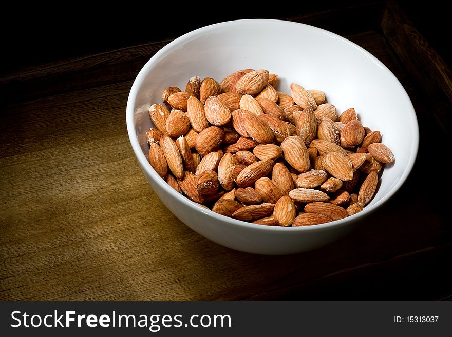 Salted almonds in white bowl