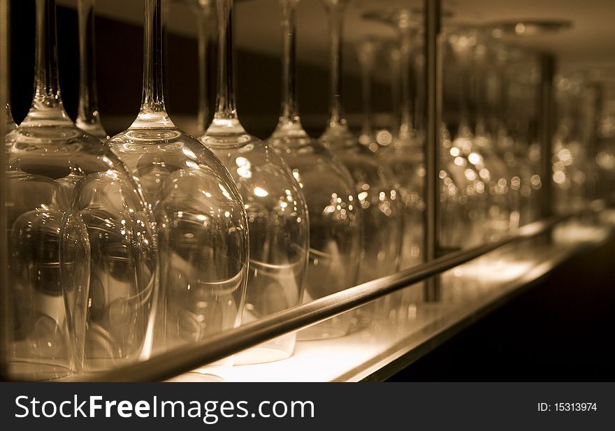 Row of clean wine glasses in a stainless steel rack in a modern bar. Row of clean wine glasses in a stainless steel rack in a modern bar