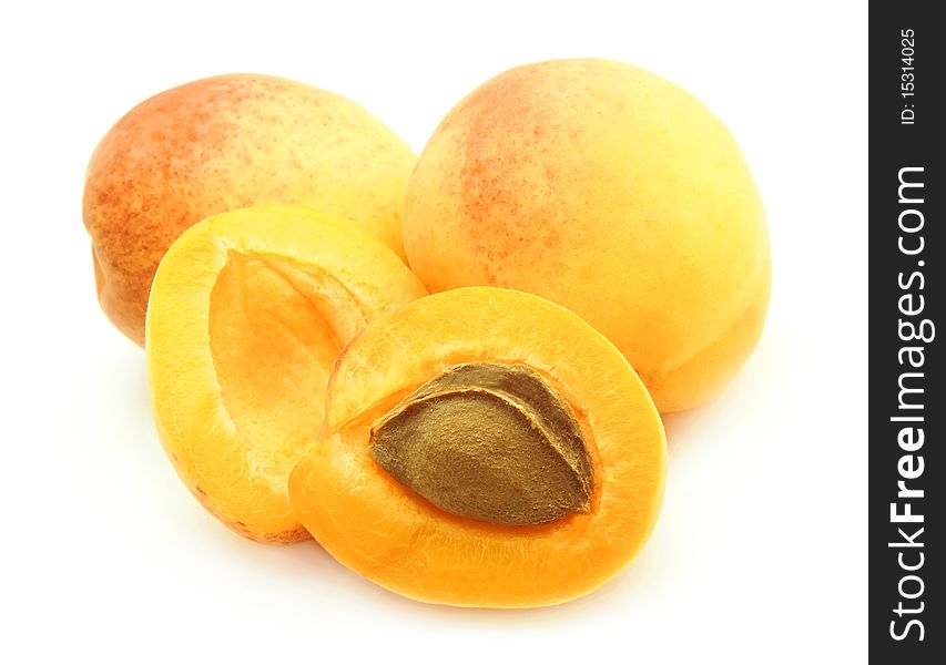 Three apricots with stone on white background