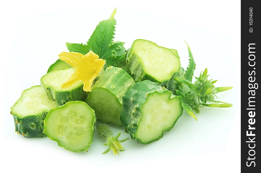 Cut cucumbers with flower on white background