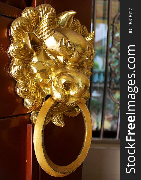 Dragon or lion door knocker guarding a doorway