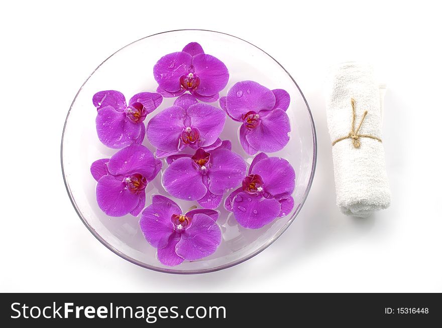 Bowl of orchid and white towel. Bowl of orchid and white towel