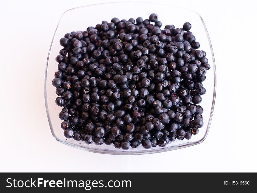 Blueberries in glass cup on isolated background