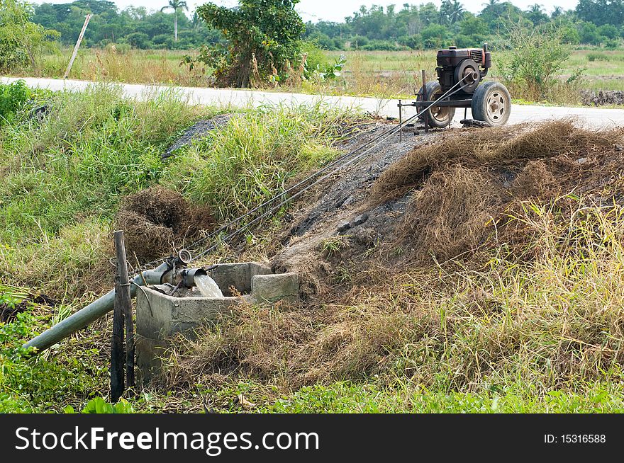 Simple irrigation pump among rice fields in Ang Thong province in Thailand. Simple irrigation pump among rice fields in Ang Thong province in Thailand.