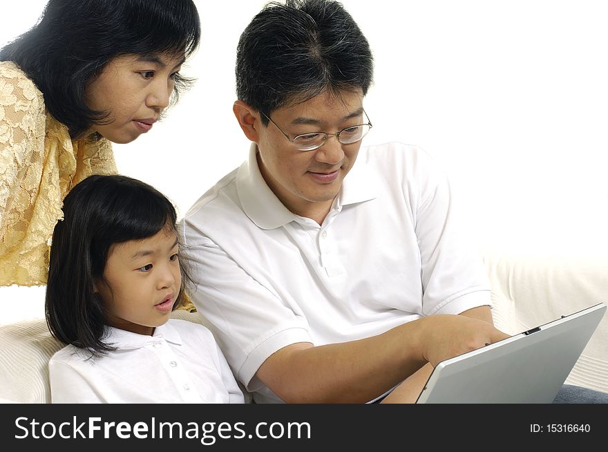 Parents and Daughter Using Laptop. Parents and Daughter Using Laptop