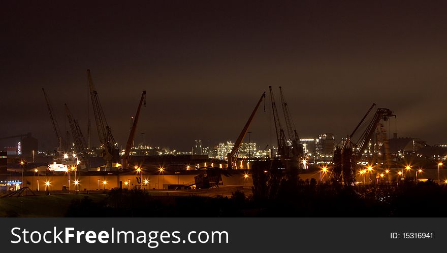 View of the harbour cranes at night time