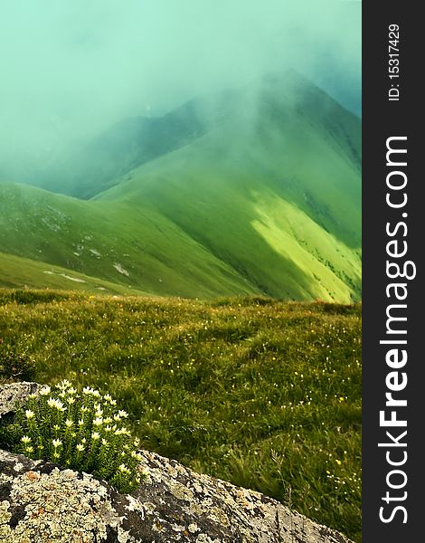 Mountain landscape with clouds and fog.