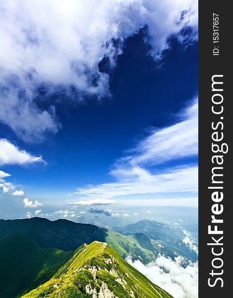 Mountain landscape with clouds and fog.