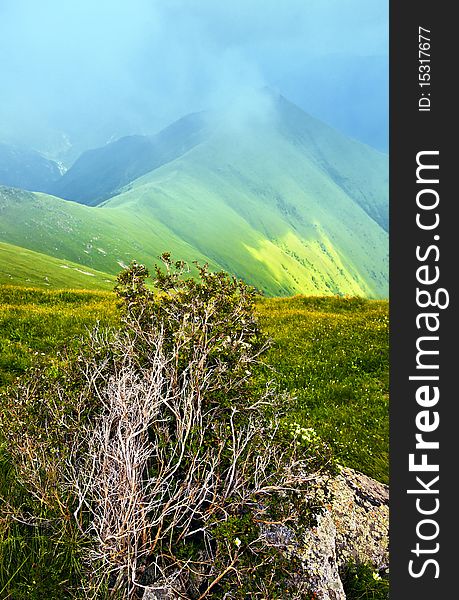 Mountain landscape with clouds and fog.