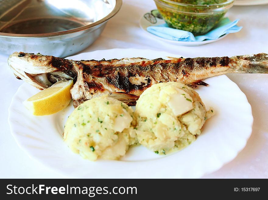 Roasted fish with potatoes in Croatian restaurant