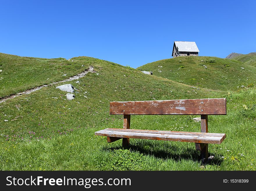 Bench and chapel in alpine mountain in France. Bench and chapel in alpine mountain in France