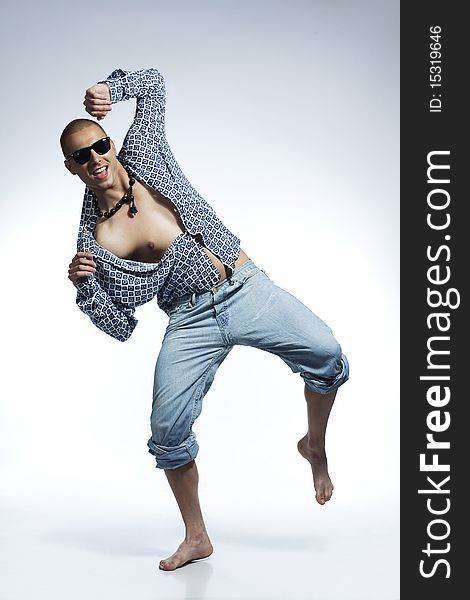 Cool young man dancing wearing casual clothes and sunglasses. Cool young man dancing wearing casual clothes and sunglasses