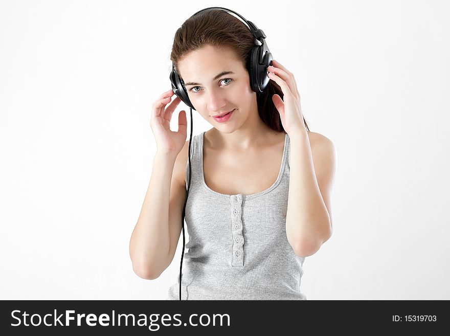 Teen girl, listening to music, enjoying life. Studio shot. Teen girl, listening to music, enjoying life. Studio shot.