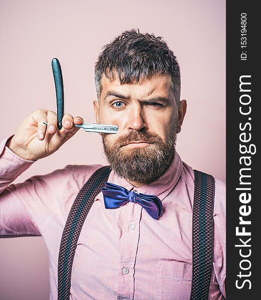 Bearded man. Male fashion. Portrait of stylish man with beard. Barber scissors and straight razor. Barber shop. Vintage