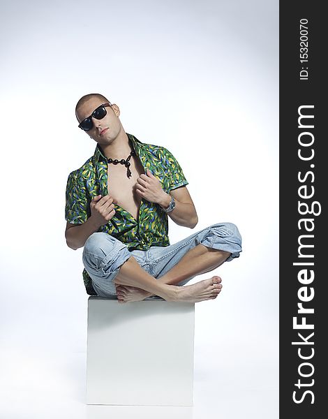 Cool young man posing wearing casual clothes and sunglasses. Cool young man posing wearing casual clothes and sunglasses