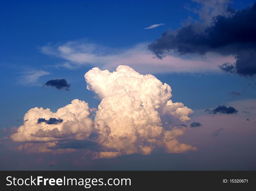 White and dark clouds in the dark blue sky. White and dark clouds in the dark blue sky