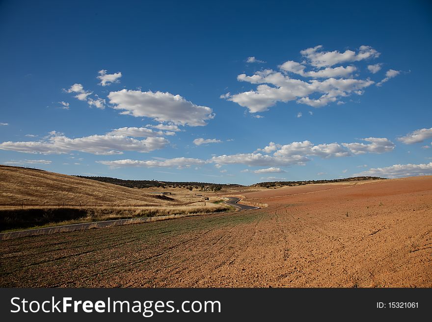 Beautiful landscape of the dry south of Spain, in Cordoba province with a road crossing in the middle. Beautiful landscape of the dry south of Spain, in Cordoba province with a road crossing in the middle