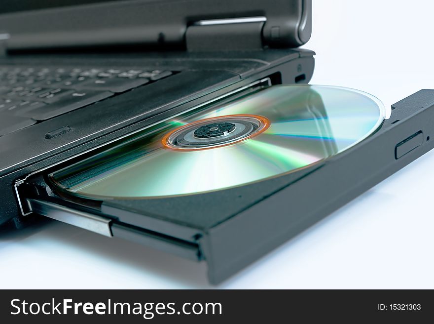 Laptop with a disk dvd. Blue tone. Laptop with a disk dvd. Blue tone