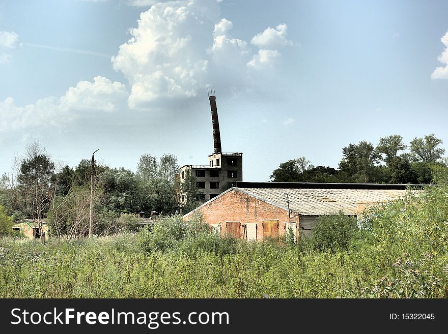 The Abandoned Building With Mowned Factory Chimney