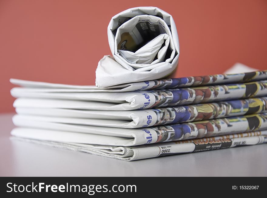 This image shows a stack of newspapers piled