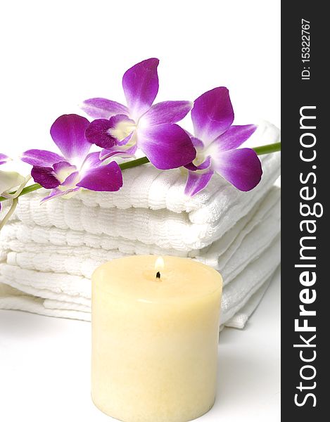 Tropical aromatherapy treatment-orchid on towel. Tropical aromatherapy treatment-orchid on towel