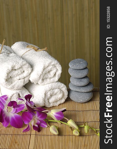 Spa and wellness: roll towels and a stack of zen pebbles