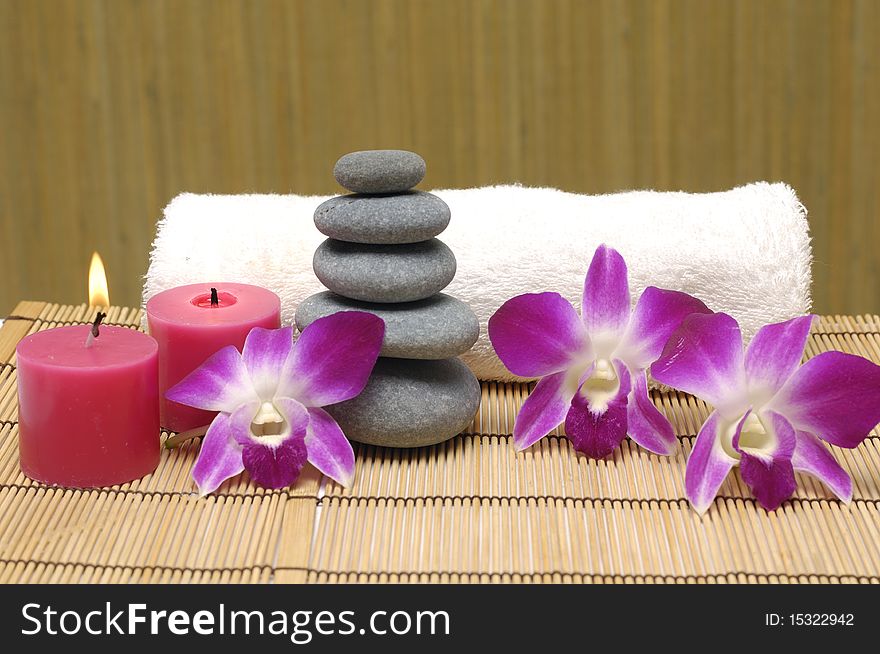 Spa with white candles on a brown backdrop