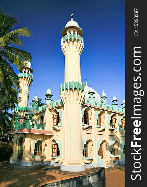 Minarets of a mosque surrounded by palm leafs, Varkala, Kerala, India