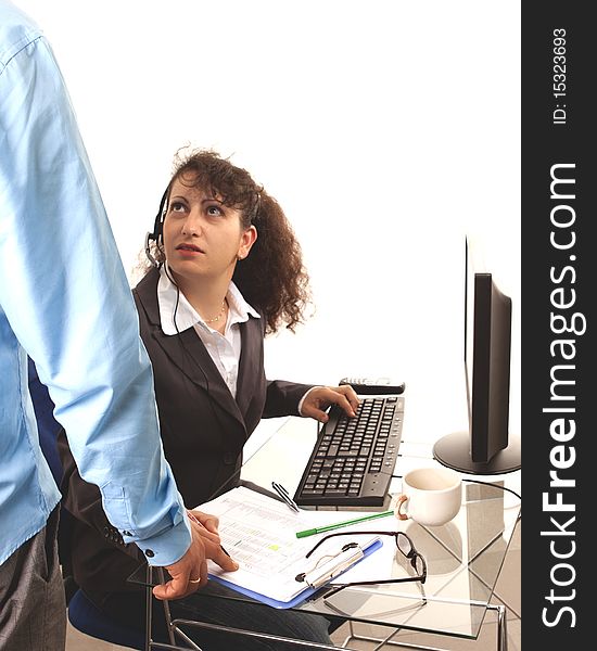 Latino Women with headset and filefolders on desk. Latino Women with headset and filefolders on desk