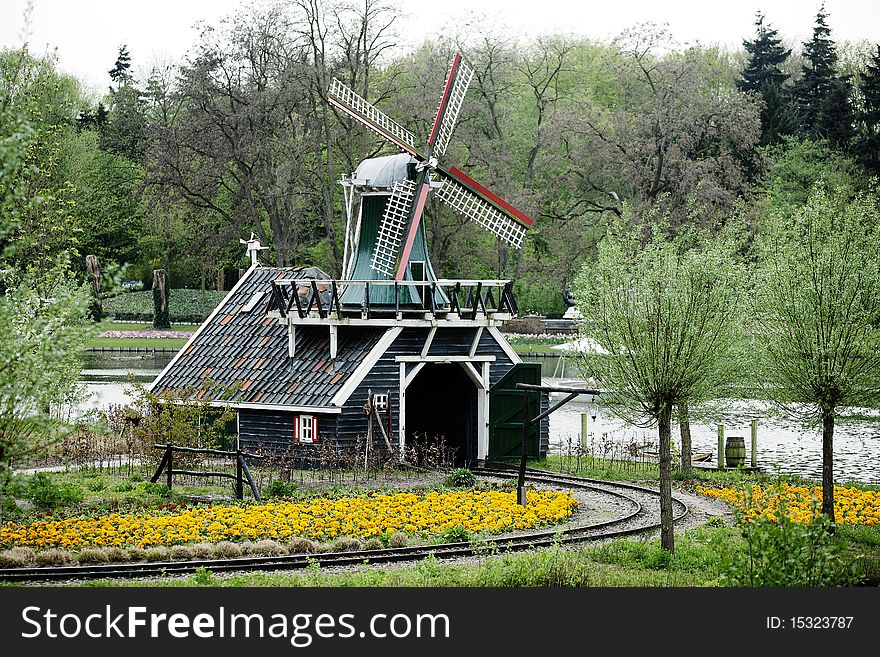 Dutch windmill in the beautiful park. Dutch windmill in the beautiful park